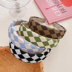 Detail view of thick sponge headbands with classic checkerboard patterns in four assorted colors