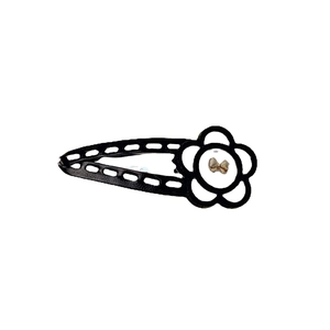 Elegant black and white floral hair clip with a golden bow accent for women's styling