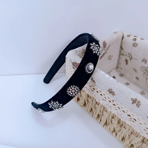 Detail of baroque black velvet headband with sparkling rhinestones and pearls decoration