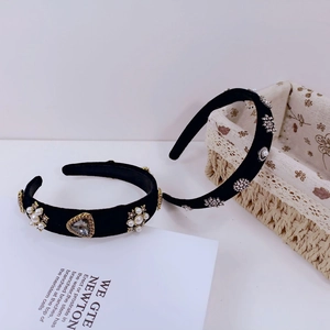 Detailed view of luxury black velvet headbands with pearls and sparkling rhinestones
