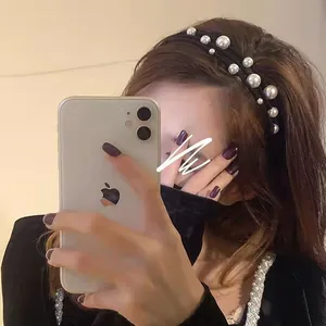 Detail shot of vintage triple-layer pearl headband worn on hair with elegant styling