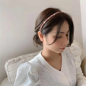Detail of elegant gold beaded headband with rhinestones worn on hair for styling