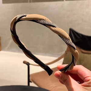 Braided twist headband with sparkling rhinestones in beige and black fabric finish