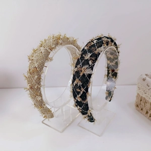 Detail of French tweed headbands in gold-beige and black-gold with metallic threads