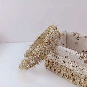 Detail of French vintage plaid headband with gold fringe and diamond stitching