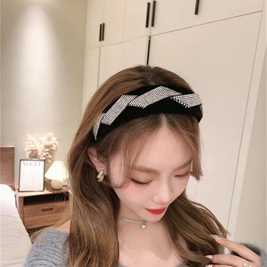 Elegant black velvet headband with luxury silver rhinestone stripes on a female model