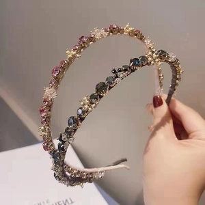 Elegant gold headband set with purple and black rhinestones in a vintage minimalist style