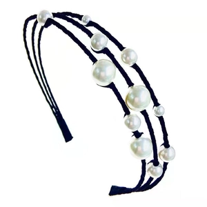 Vintage triple-layer headband with elegant white faux pearls on a black frame
