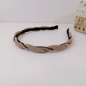 Detail of twist braided headband in beige and black with sparkling silver rhinestones