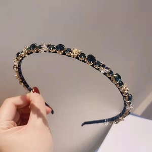 Elegant vintage gold hairband with deep blue gemstones and sparkling crystal accents
