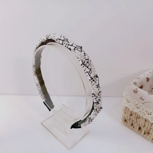 Close-up of pearl-beaded tweed headband showing black and white woven fabric details