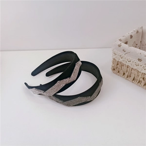Detail of luxury velvet headbands with zigzag rhinestone inlay in a cozy home setting