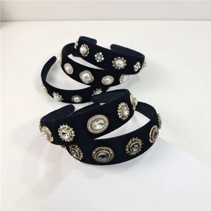 Detail of black velvet headbands with vintage pearls and sparkling crystals on white base