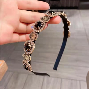 Vintage French black headband featuring antique clock charms and crystal gemstones