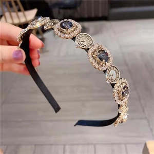 Detail of luxury headband with vintage clock charms and square rhinestones inlay