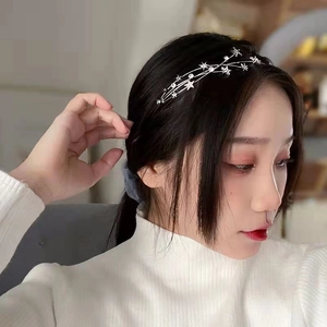 Detail of silver star headband with rhinestones and pearls on model for elegant style