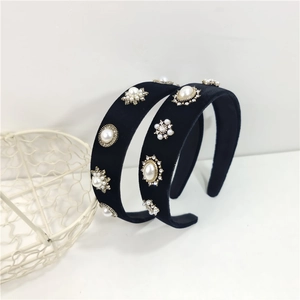 Detail of two black velvet headbands with hand-set pearls and sparkling rhinestones