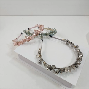 Detailed macro view of handmade crystal headbands in pink green and grey sets