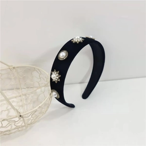 Close-up of velvet headband with white faux pearls and sparkling crystal rhinestones