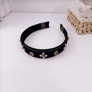 Detail of handmade baroque headband with vintage pearls and crystals on black fabric