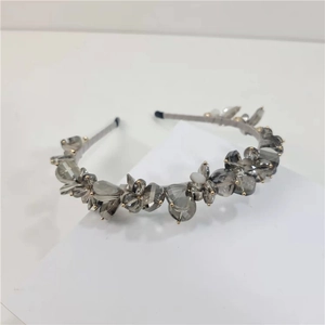 Macro view of crystal headband with grey stones, gold beads and silver metallic base