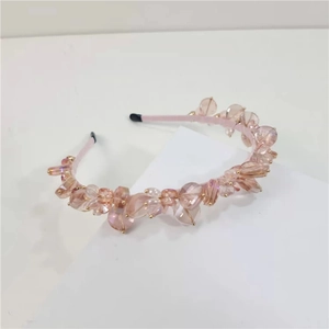 Detail of pink crystal beaded headband with luxury champagne glass beads on a satin base