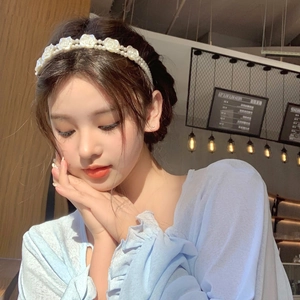 French vintage double layer headband with white roses and pearls on a model in a cafe