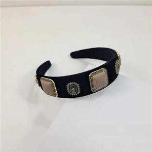 Detail of black velvet headband with square beige gems and rhinestones decoration