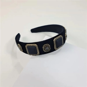 Macro detail of vintage velvet headband with crystal floral metal ornaments