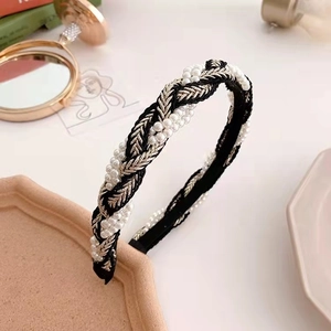 Elegant woven headband with white pearls and gold thread on black base in vintage style