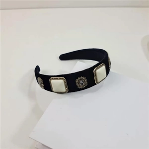 Detail view of baroque black velvet headband with square pearls and crystal gemstone studs