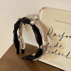 Detailed texture of tulle headbands with pearls and rhinestones on vintage books