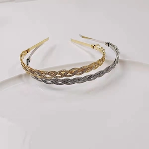 Detail of woven metallic headbands in gold and silver with vintage twisted texture