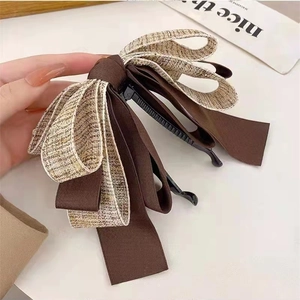 Handheld two-tone bow banana hair clip in brown tweed and satin fabric for high ponytail