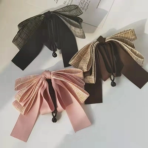 Three bow hair clips in black, brown, and pink tweed fabric for high ponytail styling