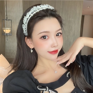 Detailed view of elegant vintage French pearl headband with delicate white mesh ruffles