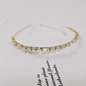 Elegant gold metal headband with white pearls and sparkling rhinestones for women