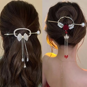Detail of vintage hair pin with pearl tassels and rose accents for elegant hairstyles