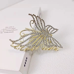 Golden butterfly hair claw clip with sparkling rhinestones for elegant styling