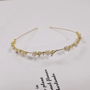Elegant gold metal headband with pearl floral clusters and leaf vintage design