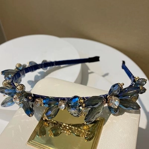 Detailed view of handmade navy blue headband with sparkling crystal floral clusters