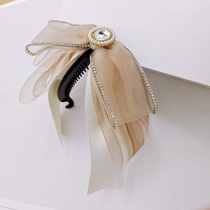 Elegante molletta a banana con fiocco in organza champagne, strass e perla centrale