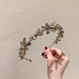 Elegant crystal flower headband with rhinestones and gold metal base in soft grey