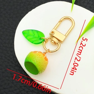 Realistic lime keychain with translucent leaf and golden hook on a white display