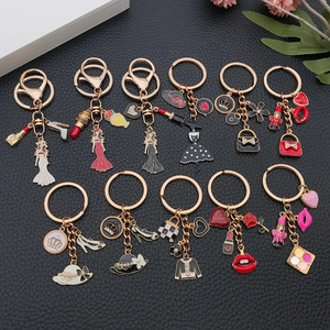 Set de porte-clés mode avec breloques émaillées rouge à lèvres, sac et couronne dorée