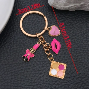 Pink cosmetics theme keychain with lipstick and eyeshadow charms on gold alloy base
