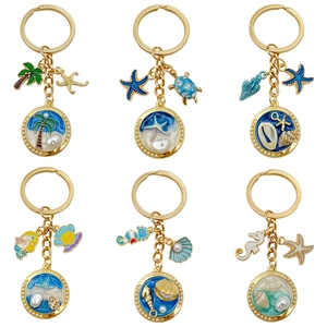 Marine theme keychains featuring sea stars and turtles in gold alloy and resin finish