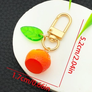 Cute cartoon orange fruit keychain with green acrylic leaf and golden D-ring clasp