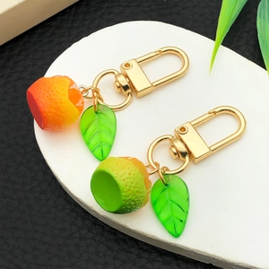 3D realistic orange and green fruit keychain set with leaf and golden metal clasp