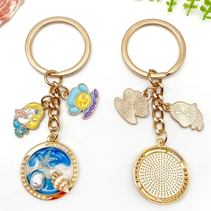 Golden ocean mermaid keychain with starfish, seashell pendants and pearls on white background